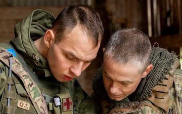 Army National Guard Soldier coordinates with Lithuanian Armed Forces Member