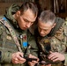 Army National Guard Soldier coordinates with Lithuanian Armed Forces Member