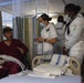 Service Members visit veterans at VA Hospital
