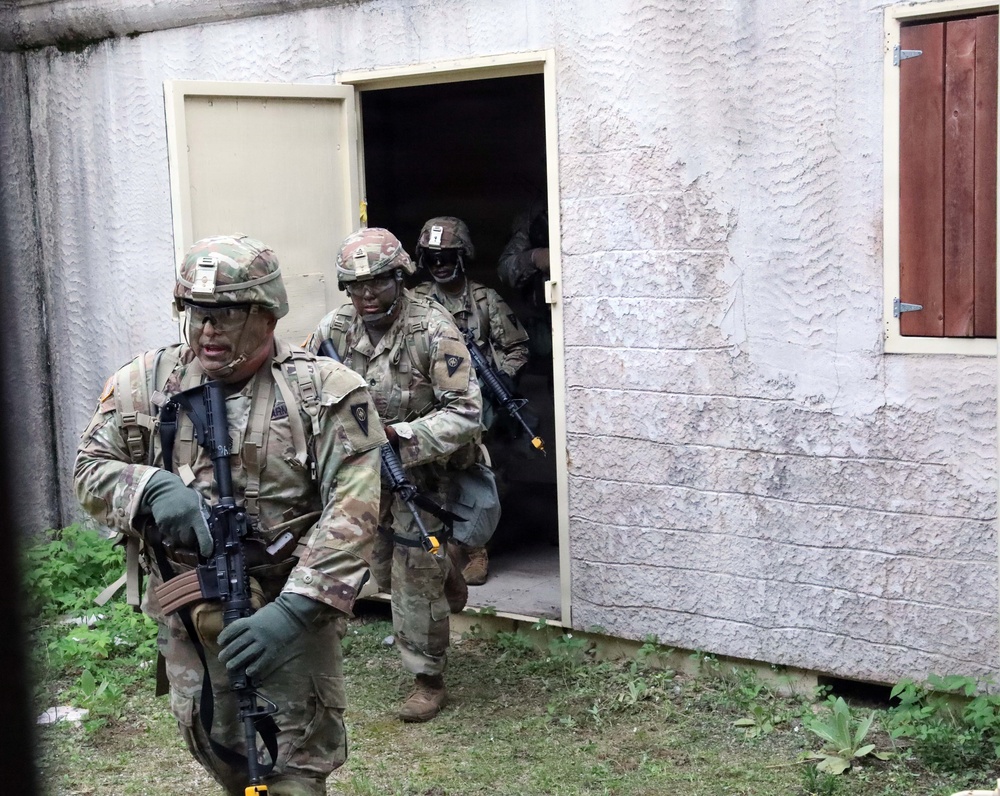 Army Reserve Best Squad competitors, from the 83rd Readiness Training Center, simulate assaulting a hostile village