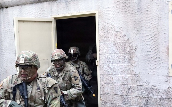 Army Reserve Best Squad competitors, from the 83rd Readiness Training Center, simulate assaulting a hostile village