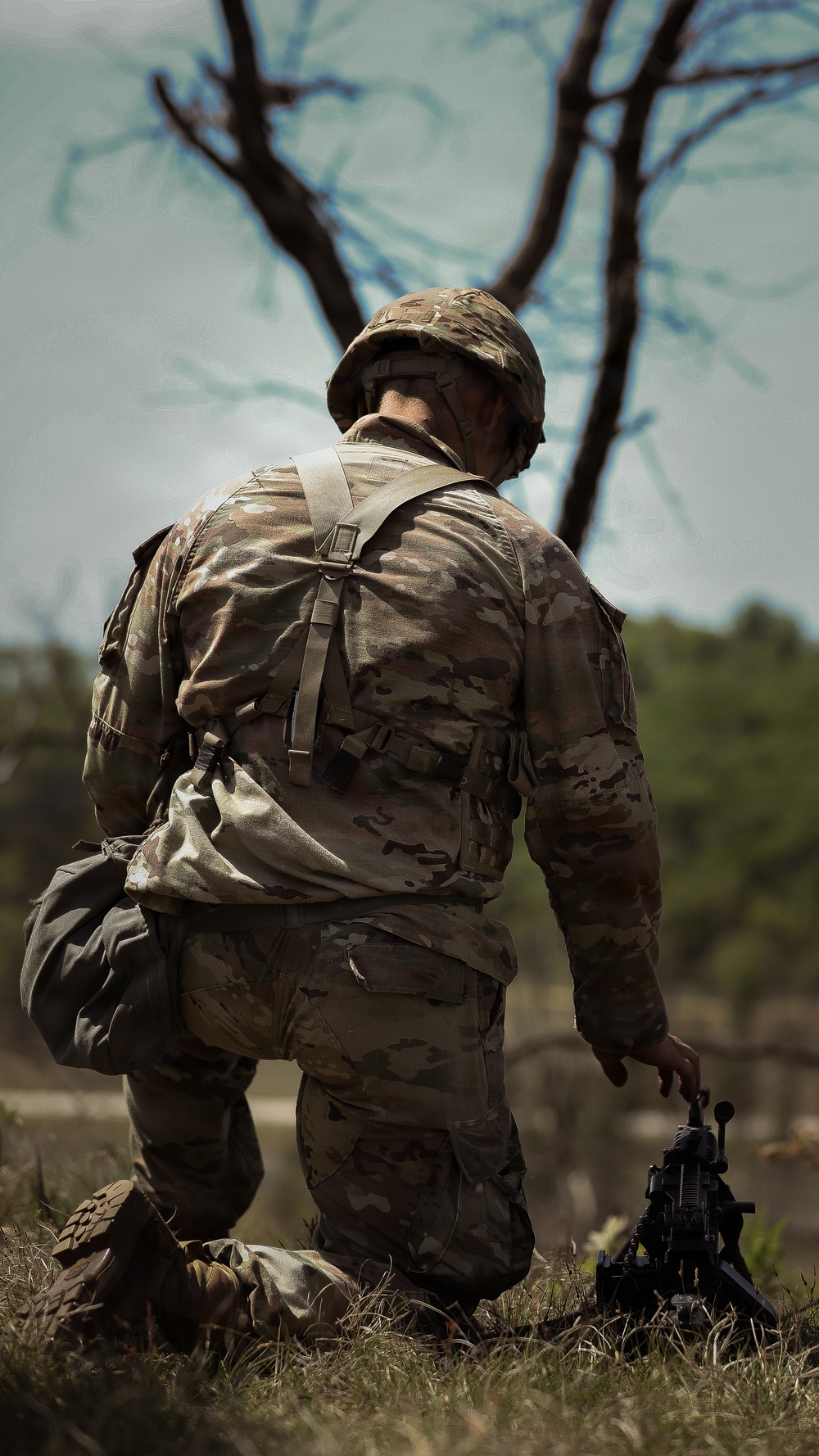 U.S. Army Soldier Equips Himself with his Weapon for Squad Movement during the Best Squad Competition