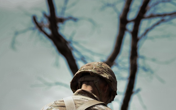 U.S. Army Soldier Equips Himself with his Weapon for Squad Movement during the Best Squad Competition
