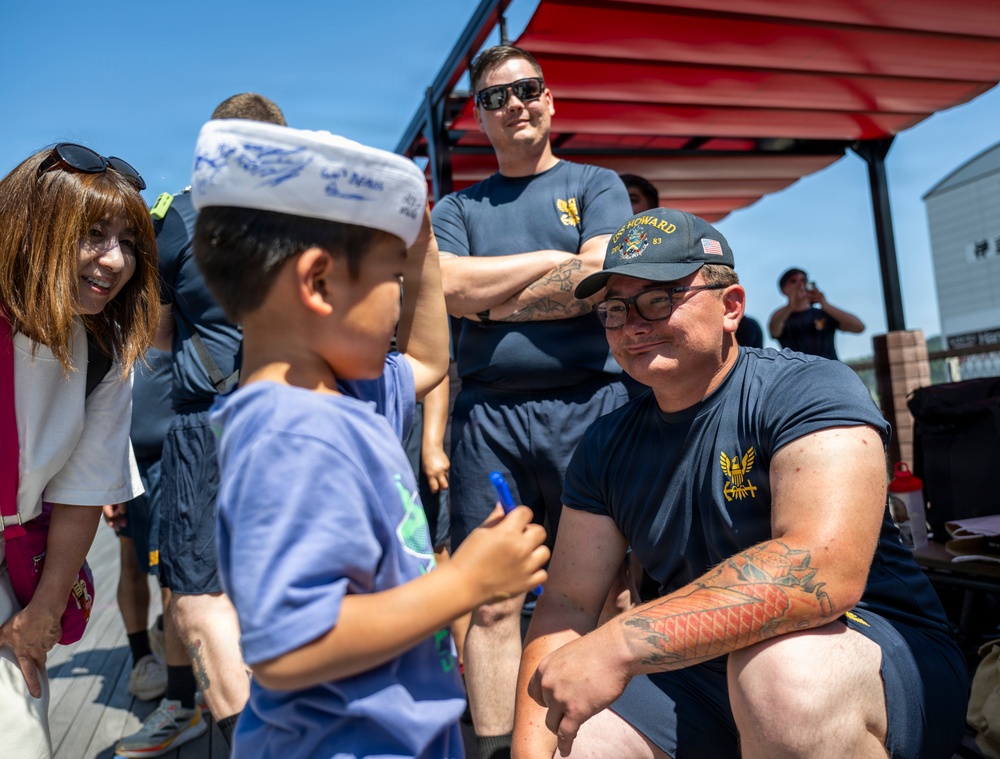 Sailors from USS Howard (DDG 83) participate in a tug-of-war competition during the 87th annual Black Ship Festival in Shimoda, Japan