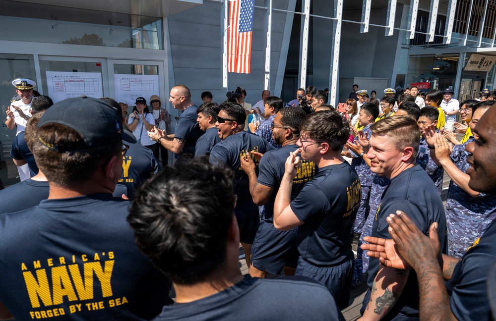 Sailors from USS Howard (DDG 83) participate in a tug-of-war competition during the 87th annual Black Ship Festival in Shimoda, Japan