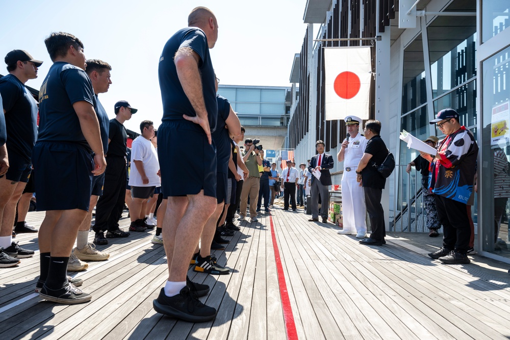 Sailors from USS Howard (DDG 83) participate in a tug-of-war competition during the 87th annual Black Ship Festival in Shimoda, Japan