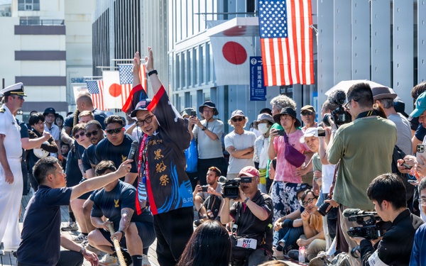 Sailors from USS Howard (DDG 83) participate in a tug-of-war competition during the 87th annual Black Ship Festival in Shimoda, Japan