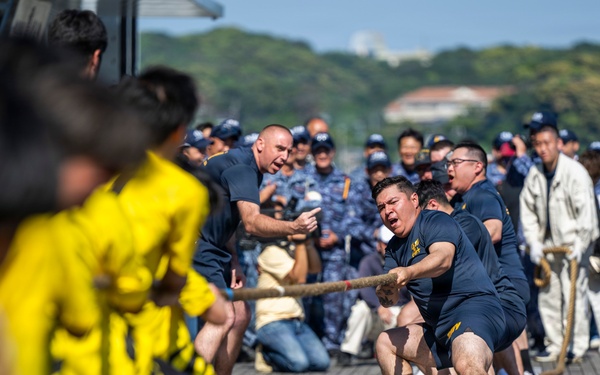 Sailors from USS Howard (DDG 83) participate in a tug-of-war competition during the 87th annual Black Ship Festival in Shimoda, Japan