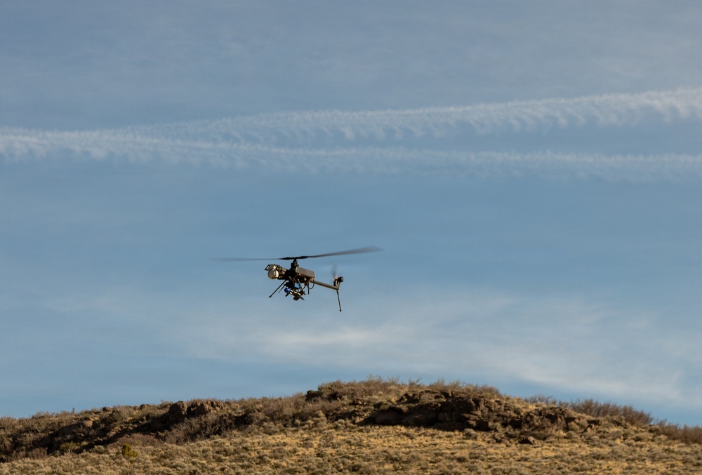 Military unmanned aerial vehicle conducts flight operations over arid terrain