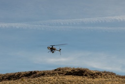 Military unmanned aerial vehicle conducts flight operations over arid terrain
