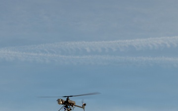 Military unmanned aerial vehicle conducts flight operations over arid terrain