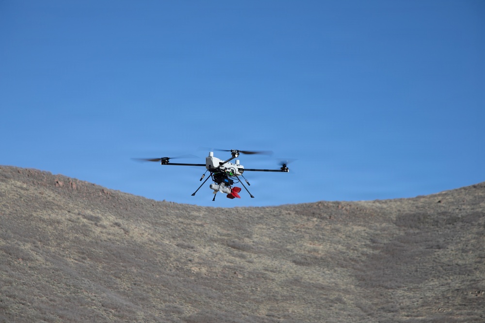 Quadcopter UAS conducts flight operations over arid desert terrain