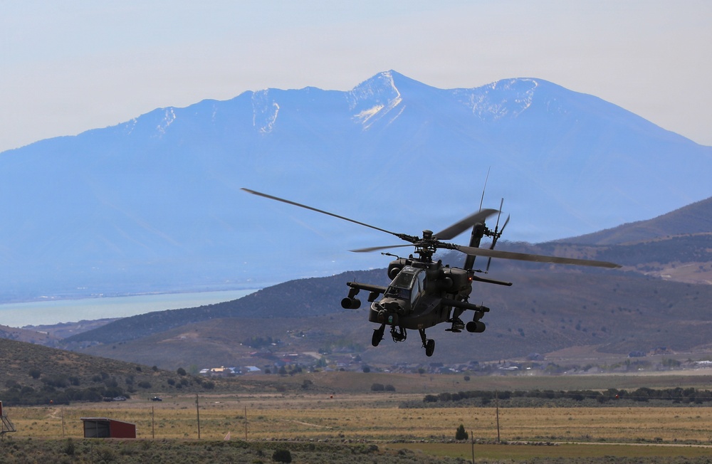 U.S. Army AH-64 Apache Attack Helicopter Conducts Low-Level Flight Operations Over Mountain Terrain