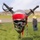 Pirate skull mascot adorned with military unit patches and crossed swords on display at outdoor event