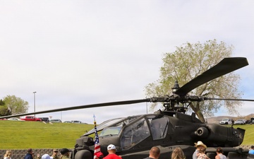 Community members gather around U.S. Army AH-64 Apache attack helicopter during public static display event
