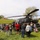Community members gather around U.S. Army AH-64 Apache attack helicopter during public static display event