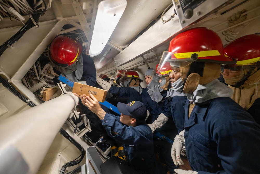 USS Mustin conducts an evening general quarters drill