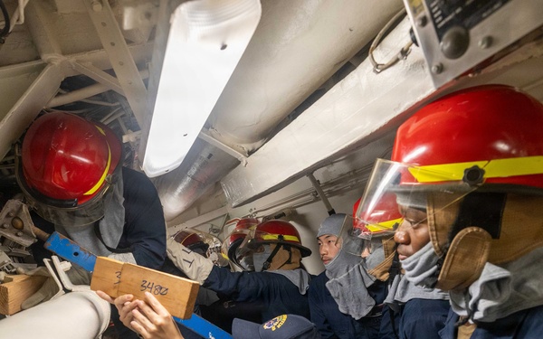 USS Mustin conducts an evening general quarters drill
