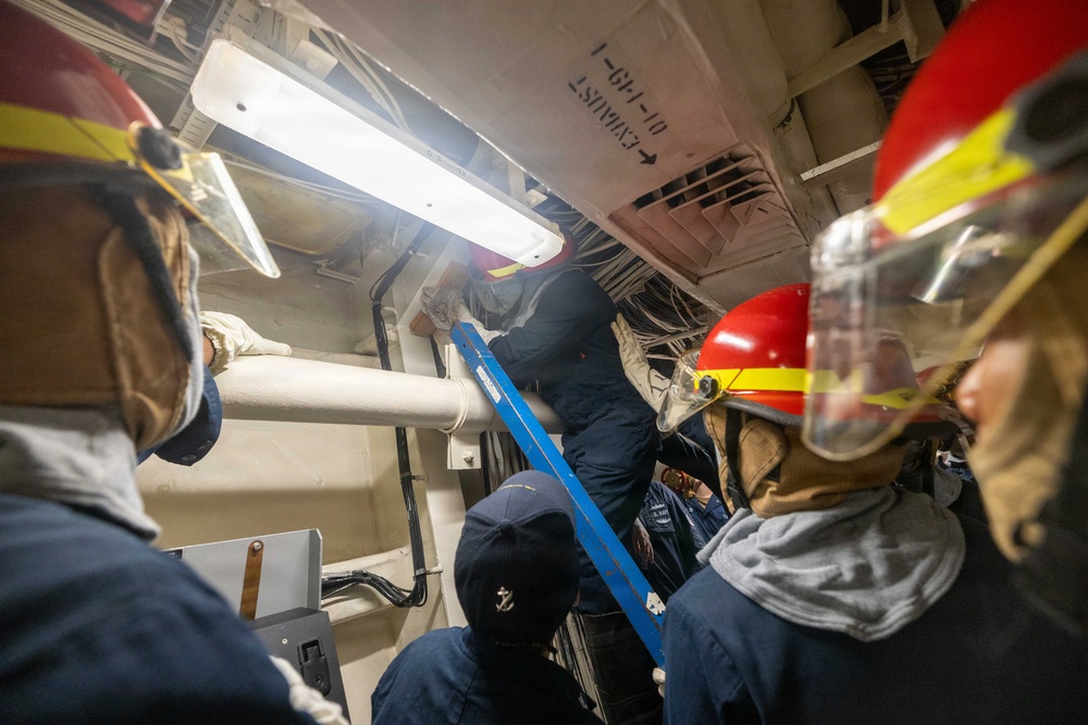USS Mustin conducts an evening general quarters drill