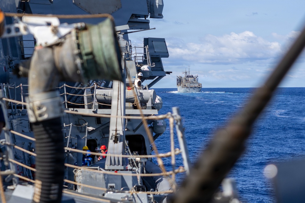 USS Mustin conducts a replenishment-at-sea with USNS Arctic