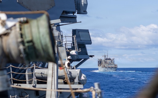 USS Mustin conducts a replenishment-at-sea with USNS Arctic