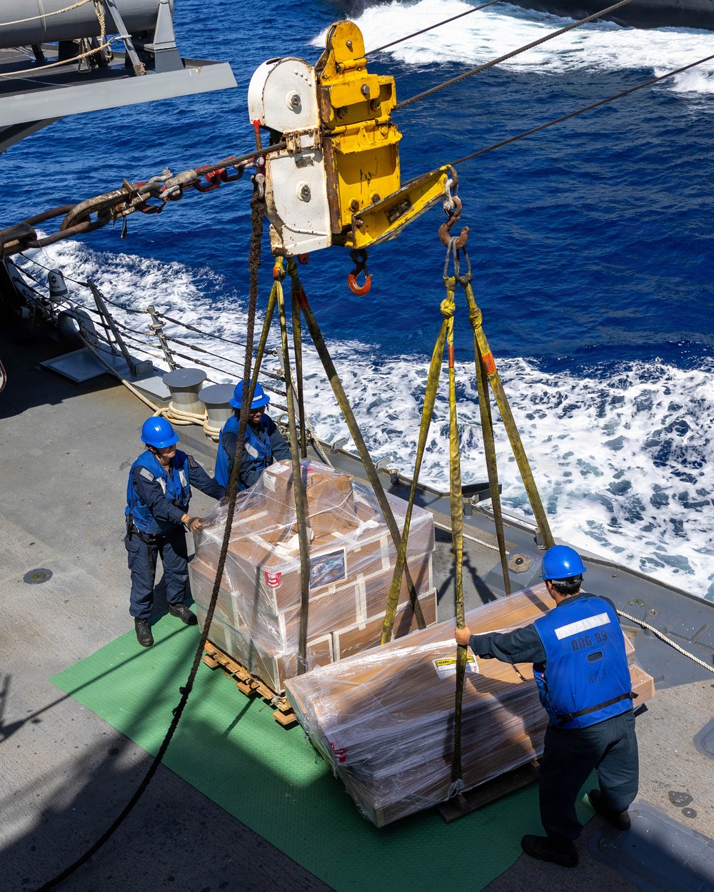 USS Mustin conducts a replenishment-at-sea with USNS Arctic