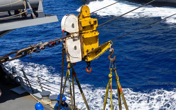 USS Mustin conducts a replenishment-at-sea with USNS Arctic