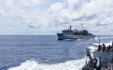 USS Mustin conducts a replenishment-at-sea with USNS Arctic