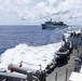 USS Mustin conducts a replenishment-at-sea with USNS Arctic