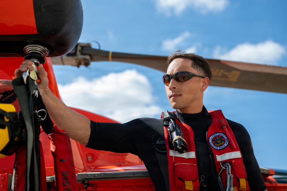Coast Guard rescue swimmer hangs gear to dry following flight operations in San Antonio