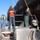 Two crew members working bow near large vessel hull Two crew members working bow near large vessel hull