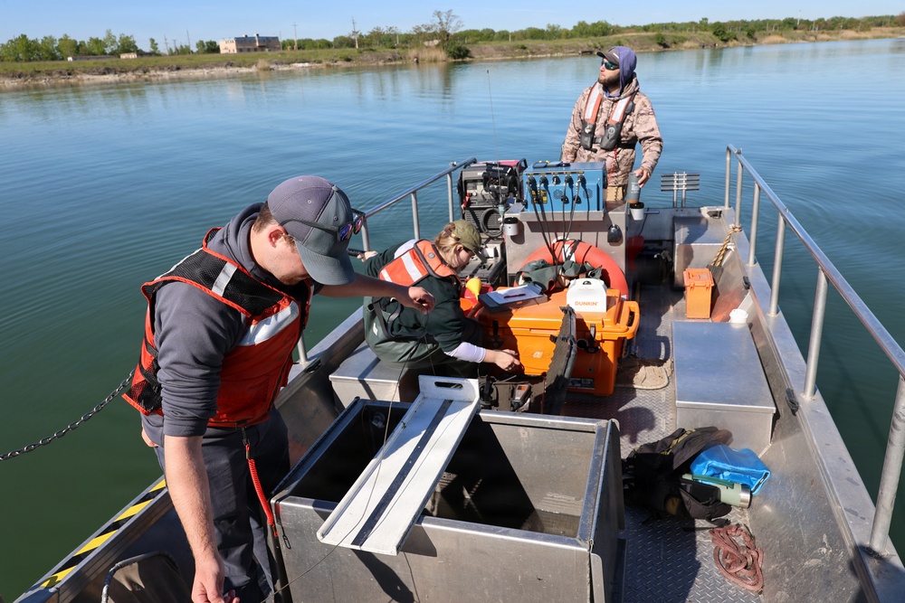 Three-person crew prepping on aluminum survey boat
