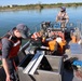 Three-person crew prepping on aluminum survey boat