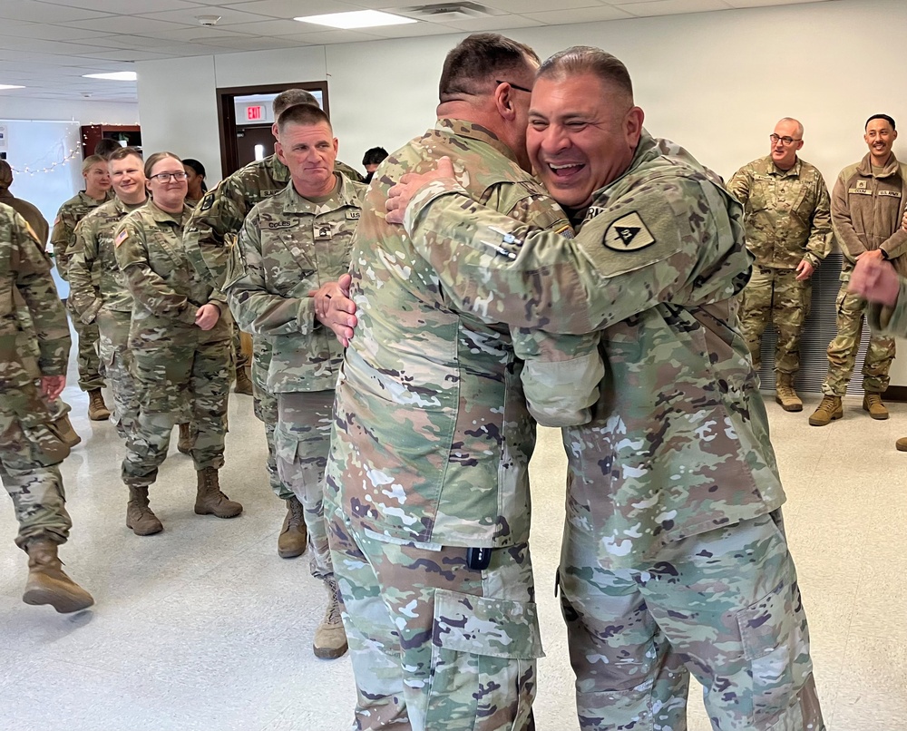 Leader embraces newly promoted master sergeant during celebration at West Fort Hood