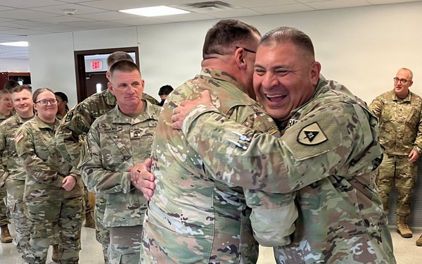 Leader embraces newly promoted master sergeant during celebration at West Fort Hood