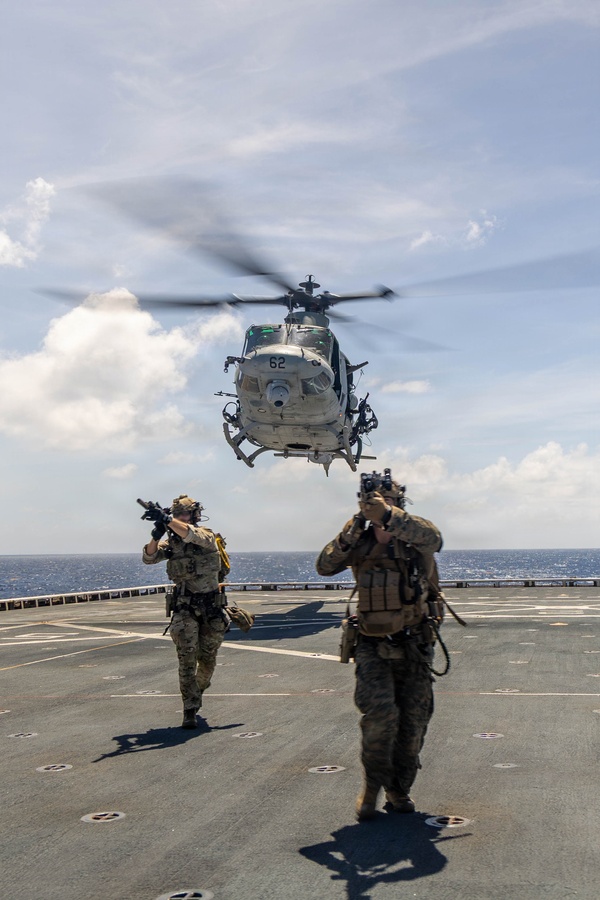 A U.S. Coast Guardsman, left, with Tactical Law Enforcement Team Pacific, and a U.S. Marine with Maritime Raid Force, Littoral Combat Force-24, move to their objective after fast-roping off of a UH-1Y Venom assigned to Marine Medium Tiltrotor Squadron (VMM) 365 (Reinforced), LCF-24, during a Maritime Interdiction Operation Full Mission Profile rehearsal aboard San Antonio-class amphibious transport dock USS Fort Lauderdale (LPD 28) while underway in the Caribbean Sea, May 22, 2026. U.S. military forces are deployed to the U.S. Southern Command area of responsibility in support of Operation SOUTHERN SPEAR, Department of War-directed operations, and the president’s priorities to disrupt illicit drug trafficking, deter malign actors and protect the homeland through continuous presence. (U.S. Marine Corps photo)