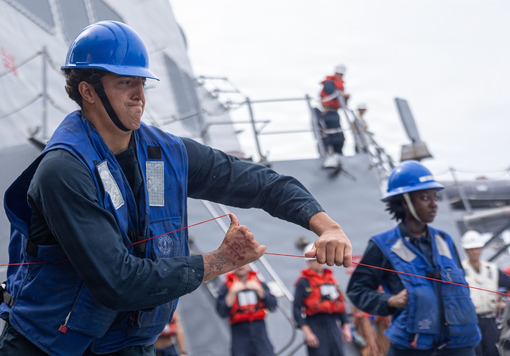 USS Mustin conducts a replenishment-at-sea with USNS Alan Shepard