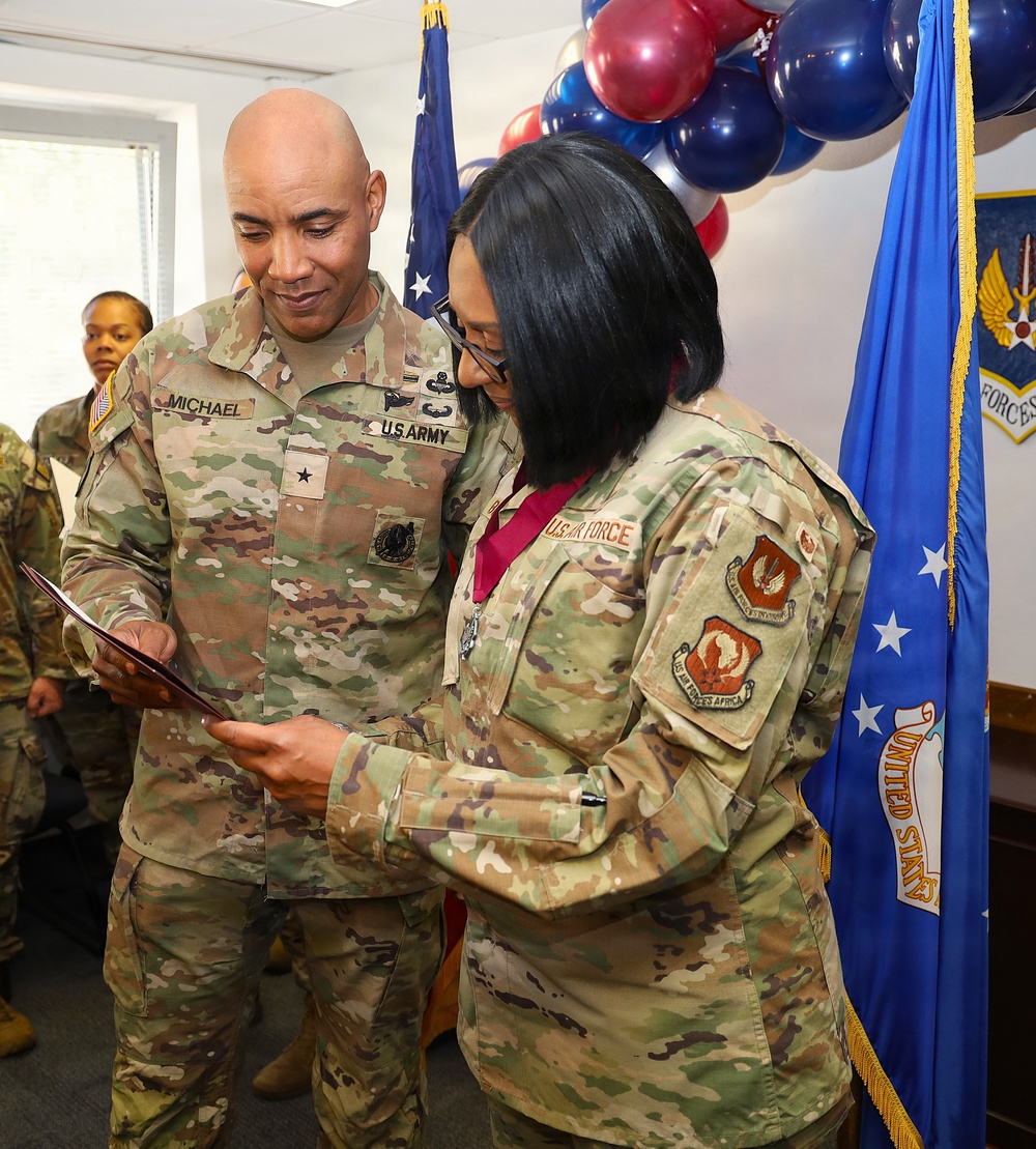 U.S. Army Brigadier General Michael and U.S. Air Force service member review document during military ceremony