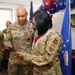 U.S. Army Brigadier General Michael and U.S. Air Force service member review document during military ceremony