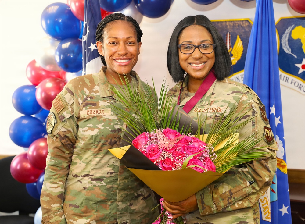 U.S. Air Force service members pose with flowers during a recognition ceremony