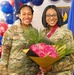 U.S. Air Force service members pose with flowers during a recognition ceremony