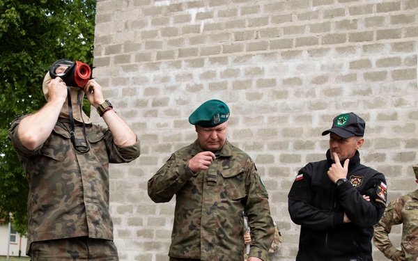 U.S. Army engineers and Polish firefighters exchange mechanical door breaching techniques at Bemowo Piskie