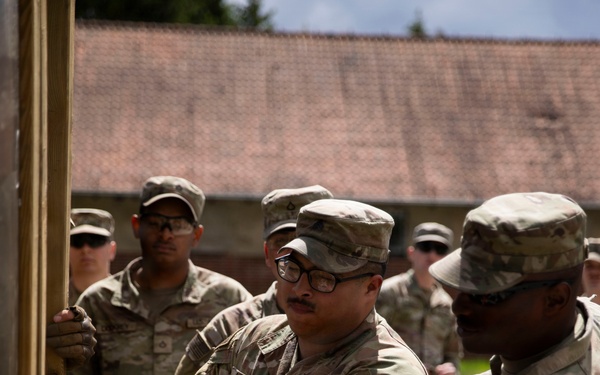 U.S. Army engineers and Polish firefighters exchange mechanical door breaching techniques at Bemowo Piskie