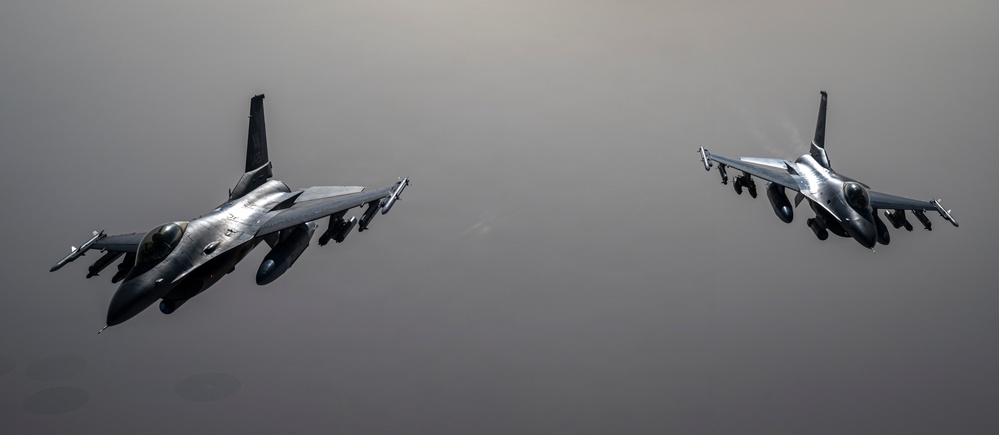 KC-135 conducts refueling operation with F-16 aircraft