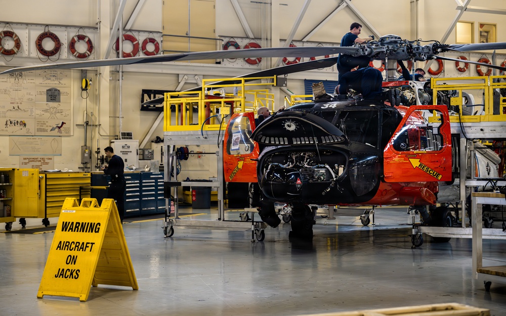 Coast Guard aircraft maintainers conduct maintenance on helicopter in Kodiak, Alaska