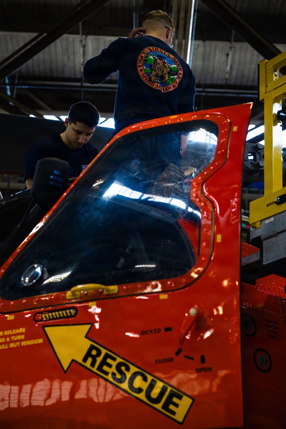 Coast Guard aircraft maintainers conduct maintenance on helicopter in Kodiak, Alaska