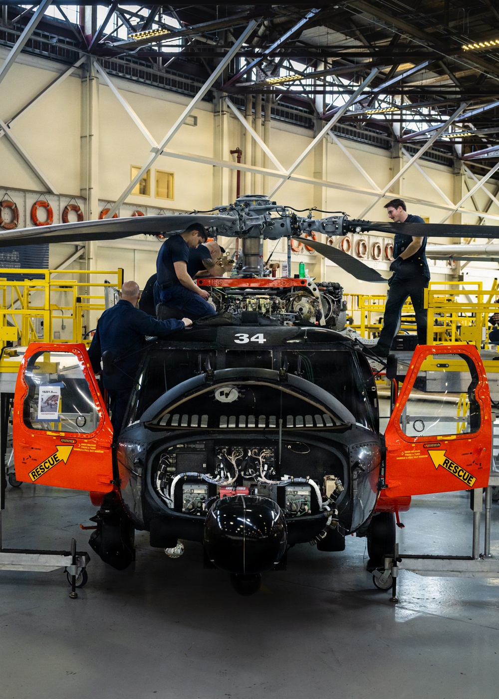 Coast Guard aircraft maintainers conduct maintenance on helicopter in Kodiak, Alaska