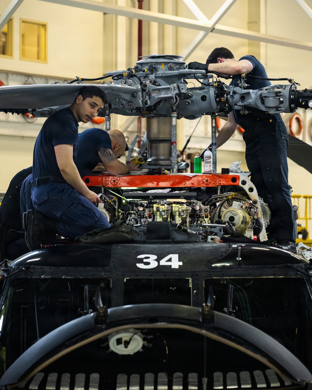 Coast Guard aircraft maintainers conduct maintenance on helicopter in Kodiak, Alaska