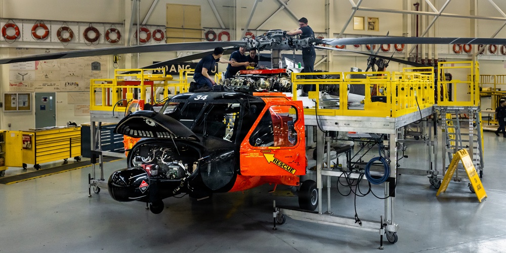 Coast Guard aircraft maintainers conduct maintenance on helicopter in Kodiak, Alaska