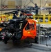 Coast Guard aircraft maintainers conduct maintenance on helicopter in Kodiak, Alaska